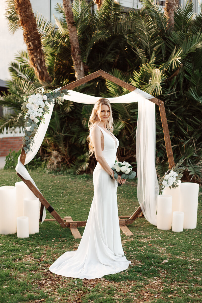 Flameless Wax Pillar Candles Framing a Wedding Arch