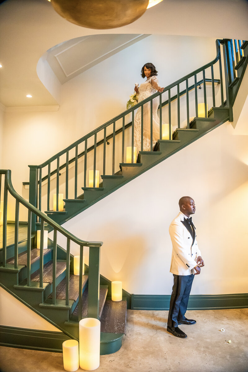 Flameless Candle Luminaries Lining a Grand Staircase for a Bride Dress Reveal